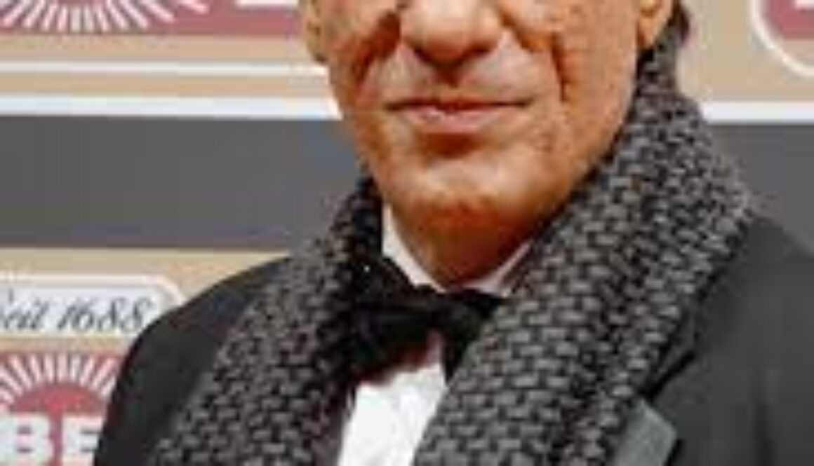 A man in a black jacket and bow tie.