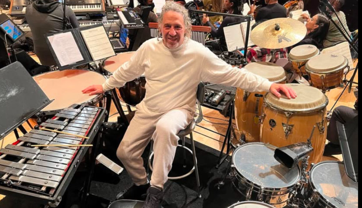 A man sitting in front of many instruments.
