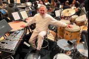 A man sitting in front of many instruments.