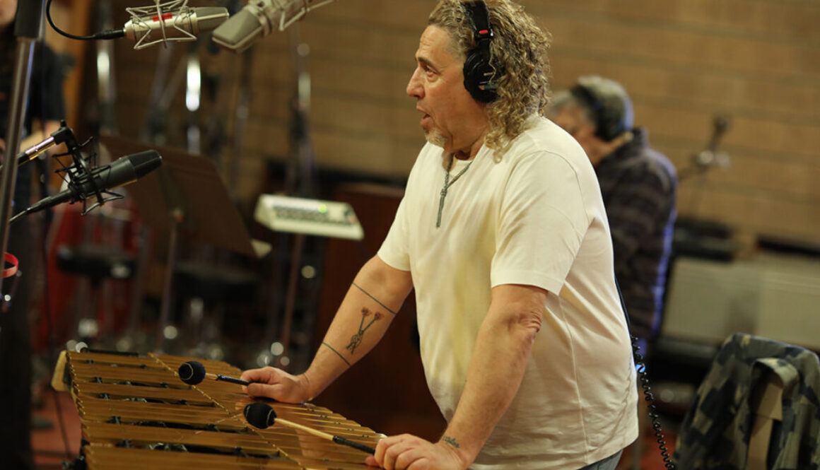 Man playing vibraphone in recording studio.