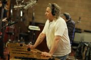 Man playing vibraphone in recording studio.
